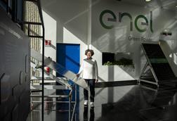 Enel's head of the advanced processes and materials characterization lab poses next to a state-of-the-art photovoltaic panel